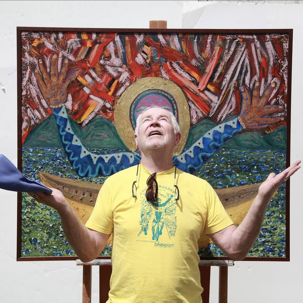 Francis X. Donovan standing with arms raised in front of Seek Grace at Studio X