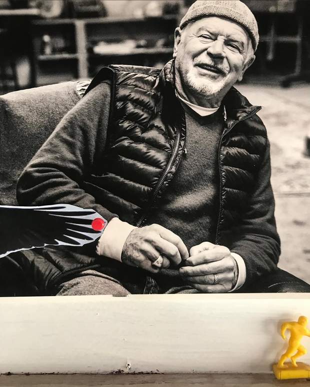 Black and white portrait of Frank sitting in the studio, laughing